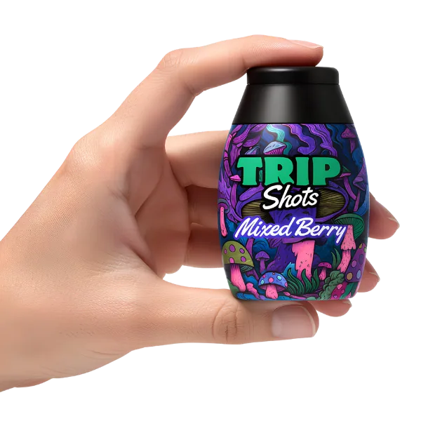 Hand holding a bottle of mixed berry Trip Shots