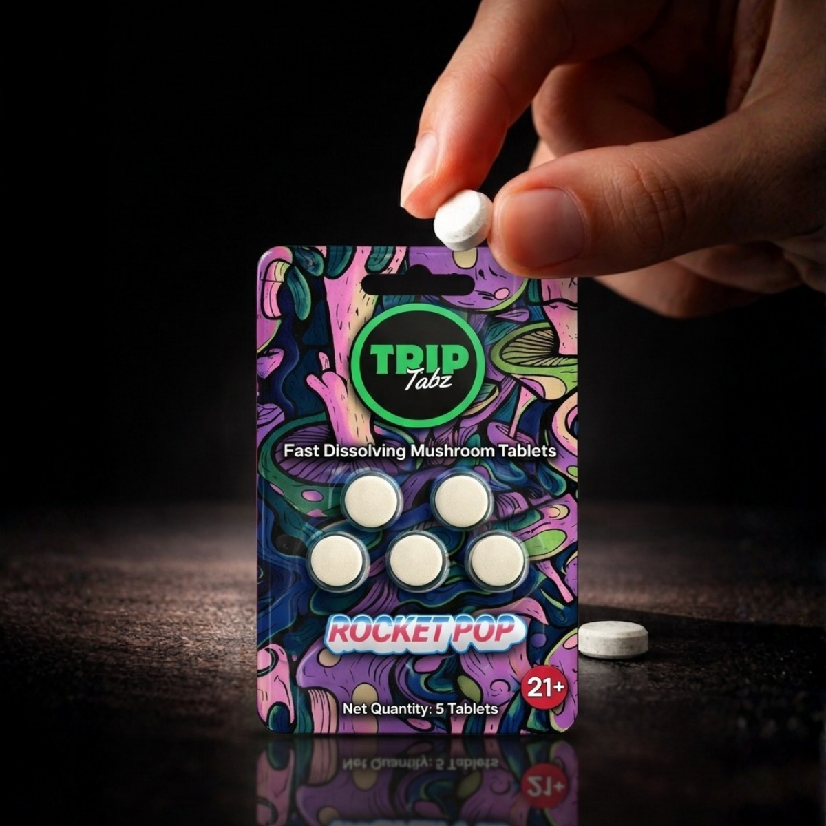 TRIP Tabz fast dissolving mushroom tablets packaging with a hand holding a tablet.