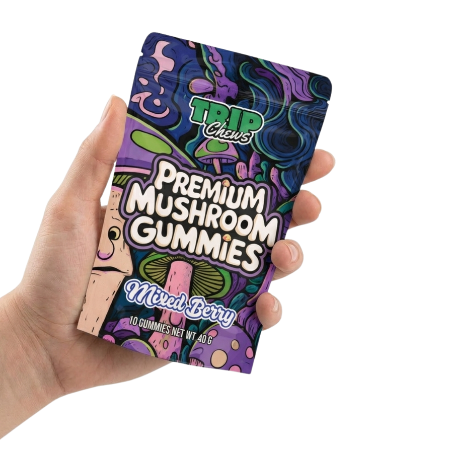 Hand holding a colorful package of Trip Chews Premium Mushroom Gummies on a white background