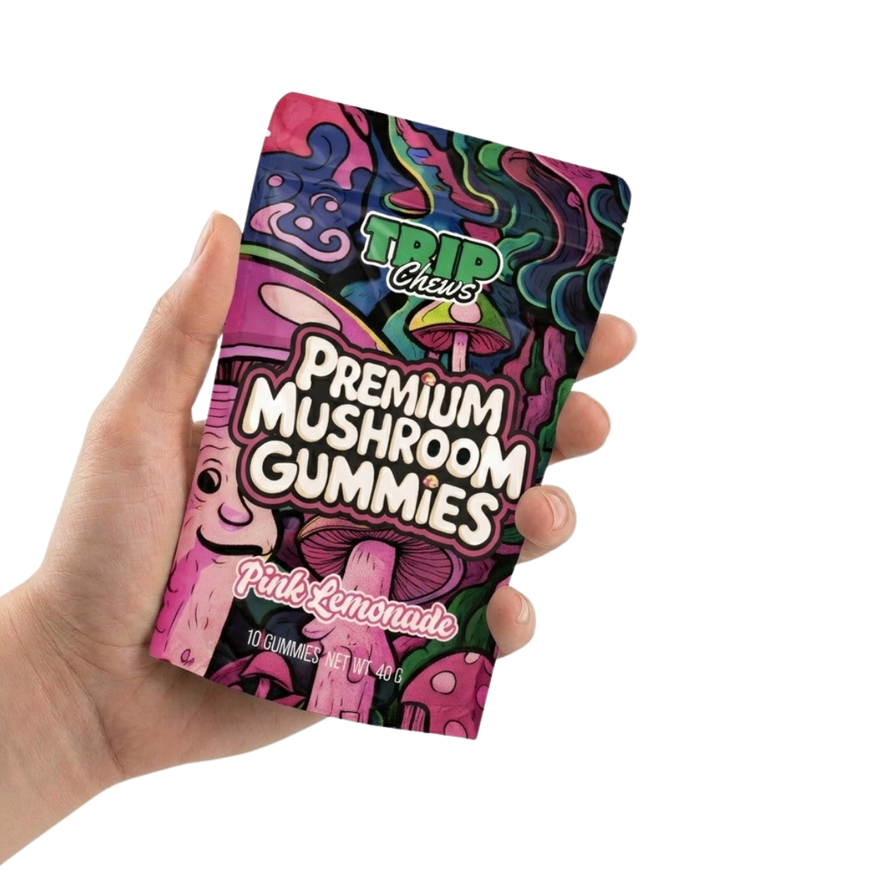 Hand holding a colorful package of Trip Chews Premium Mushroom Gummies.