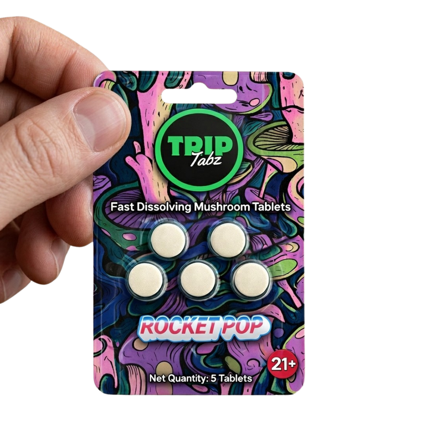 Colorful packaging of TRIP Tabz fast-dissolving mushroom tablets with a hand holding it.