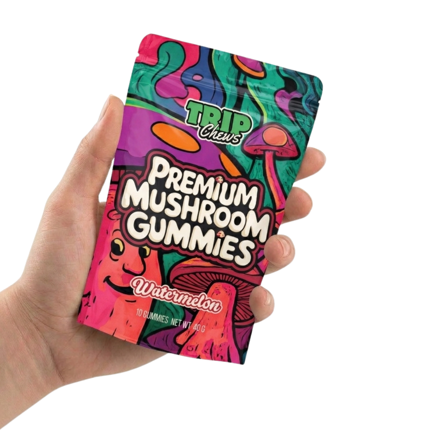 Colorful package of Trip Chews Premium Mushroom Gummies held in a hand against a white background